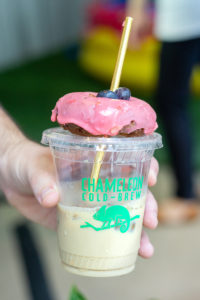 Bougie's berry donut on top of an iced latte from Chameleon Cold Brew
