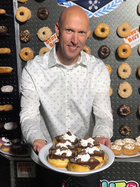Bryan in front of his industrial Donut Wall