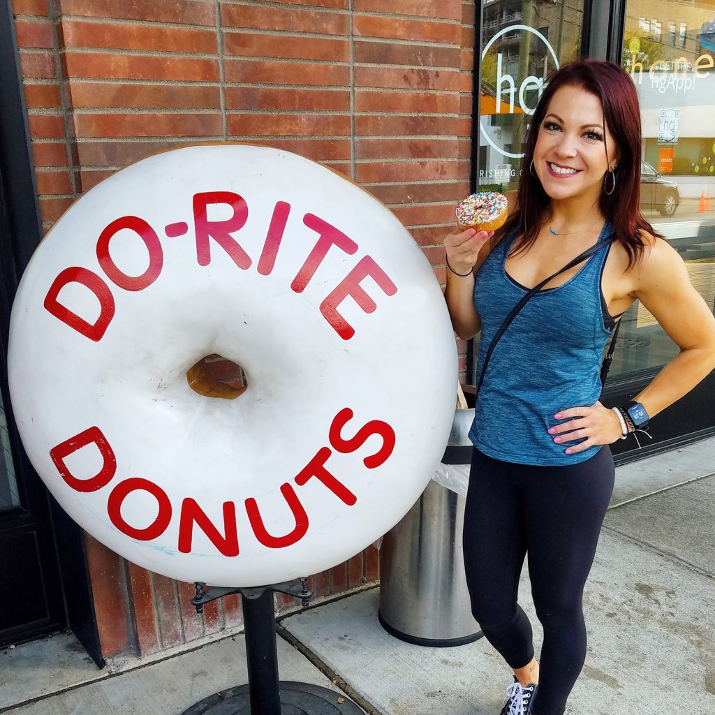 Erin Good posing with the Do-Rite Donuts sign in Chicago, IL