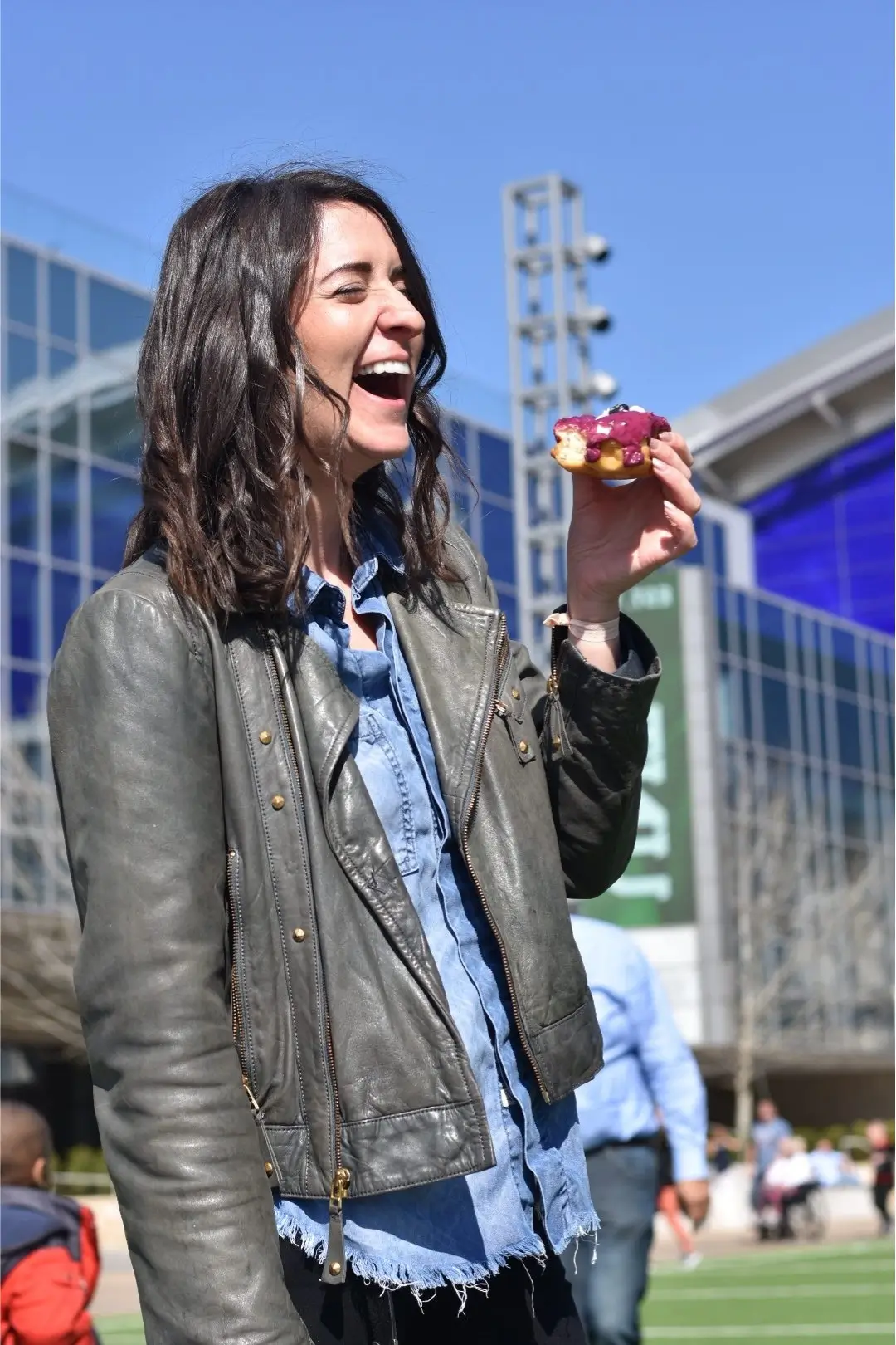 Rory Gallagher, Donut Digest founder, smiling while holding a fresh donut
