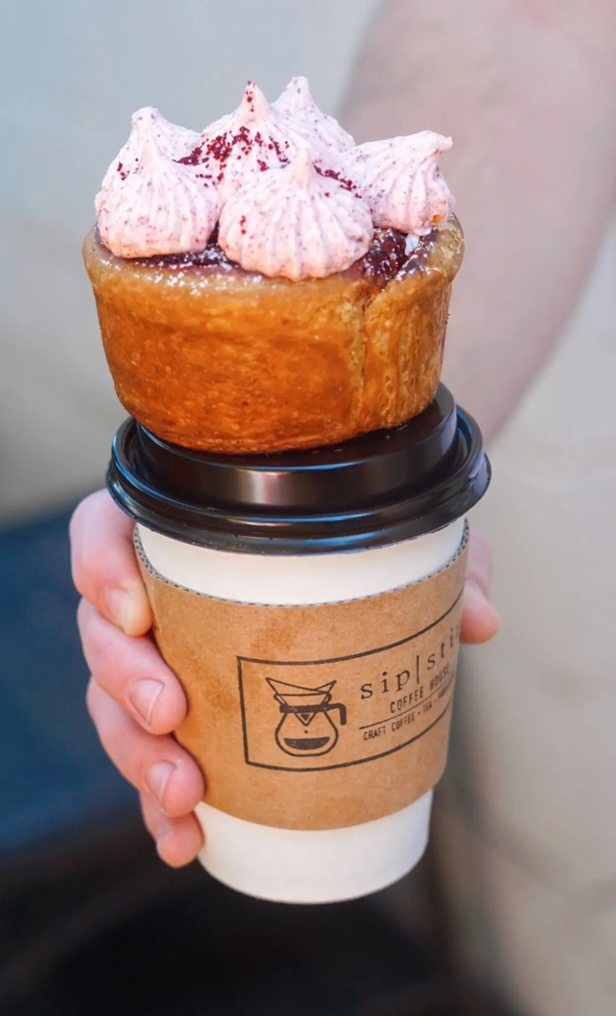 Cronut pastry served alongside a fresh cup of coffee