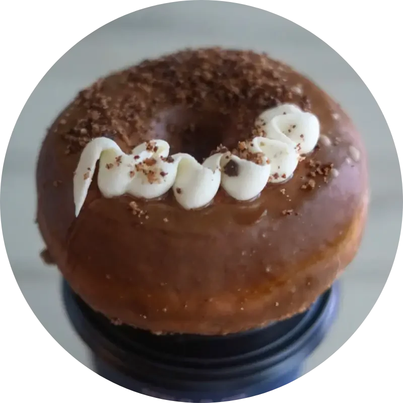 Classic pairing of a glazed donut and a cup of hot coffee