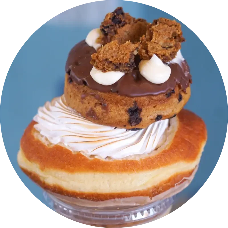 Fresh donut served with a steaming cup of coffee